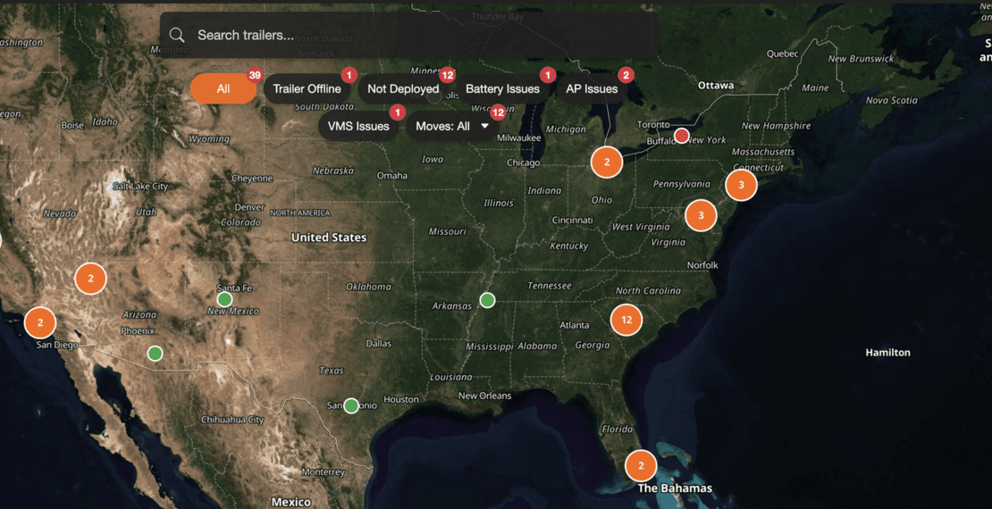 A close-up of the MySharpvue fleet map: clustered unit pins across North America, trailer search, and one-click issue filters with live counts for offline, battery, AP, and VMS issues.