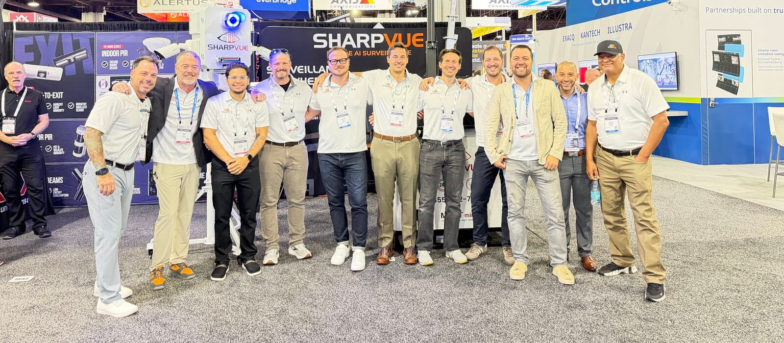The Sharpvue team at booth 1641 at GSX 2026, in front of a MAST trailer mast and Sharpvue banners on the show floor.